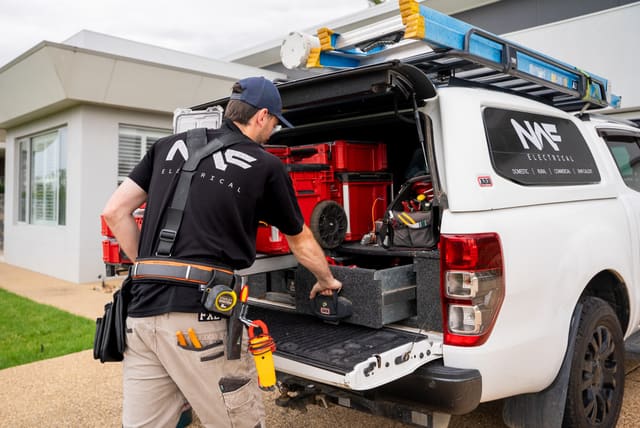 Nelson getting tools from the drawers of his NAF Electrical ute